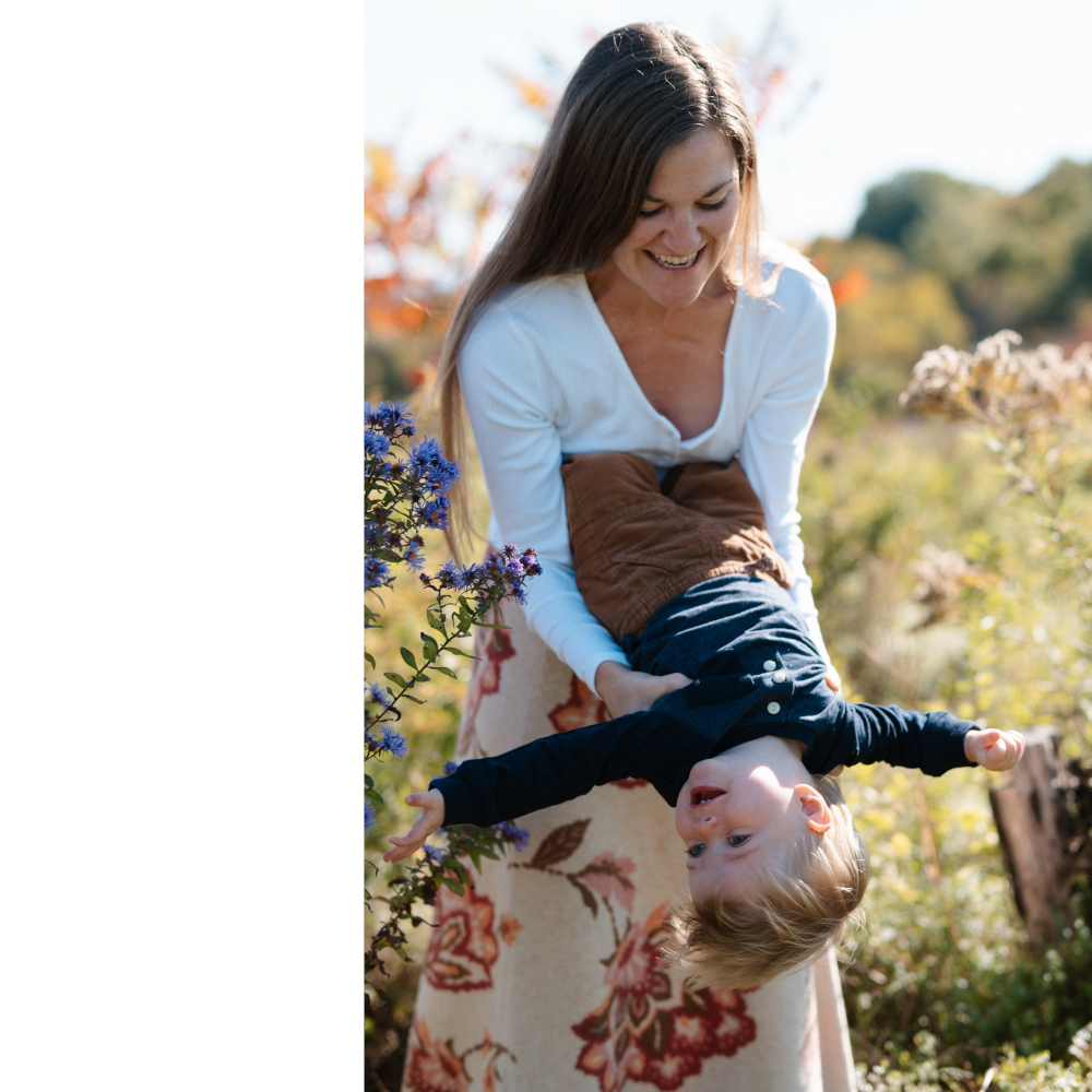 Woman in a field of flowers with a child