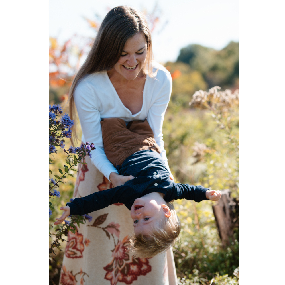 Woman in a field of flowers with a child